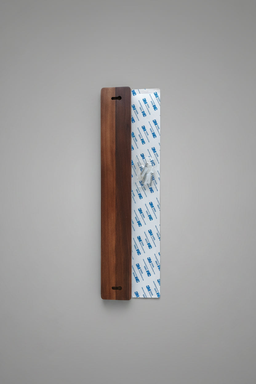 Wooden strip with 3M tape on a wooden surface