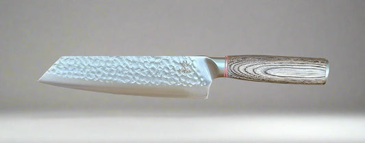 Rugged Stainless Steel chef knife with hammer-forged blade and Pakka wood handle.