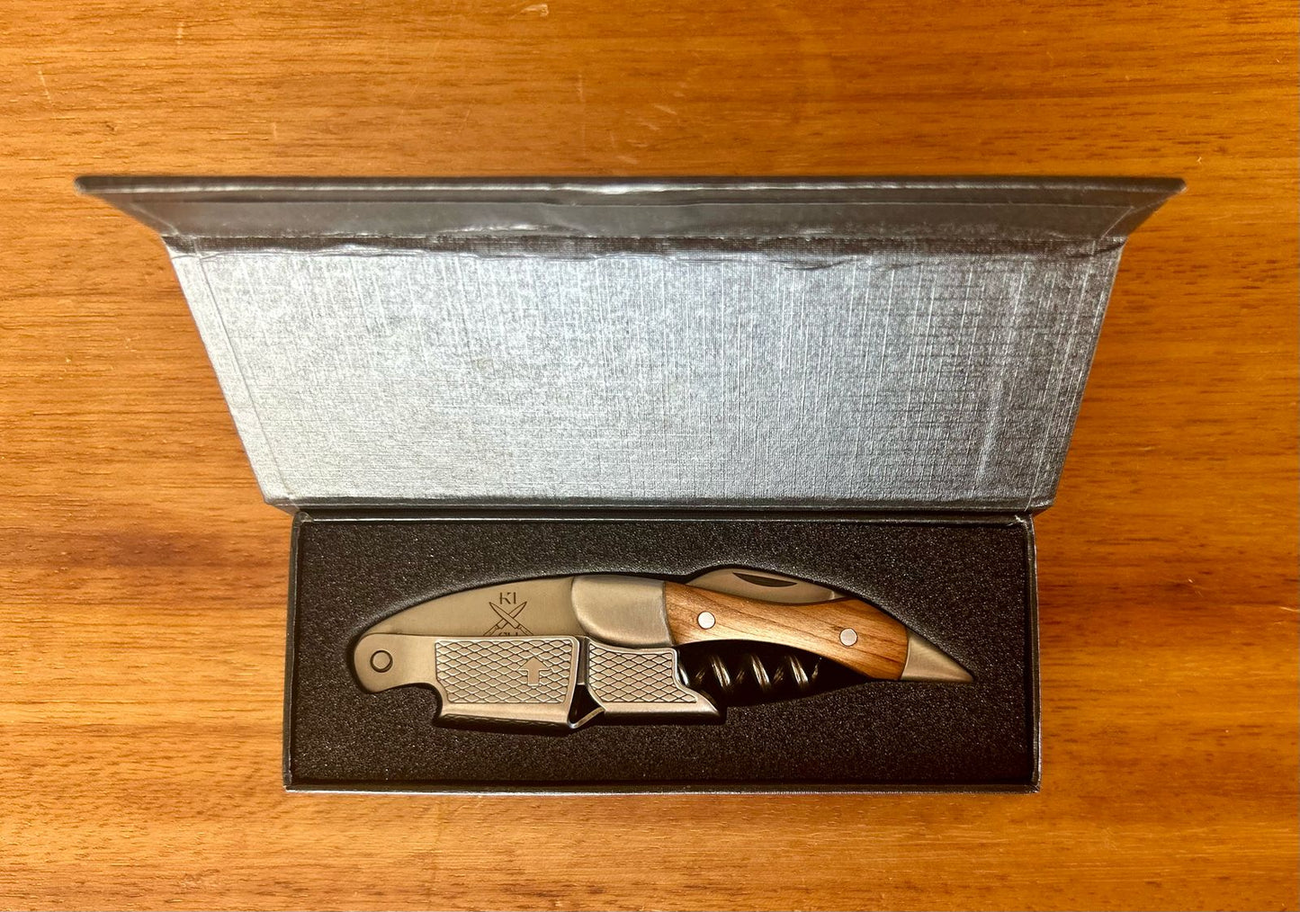 Rosewood wine corkscrew with stainless steel tip in elegant packaging.