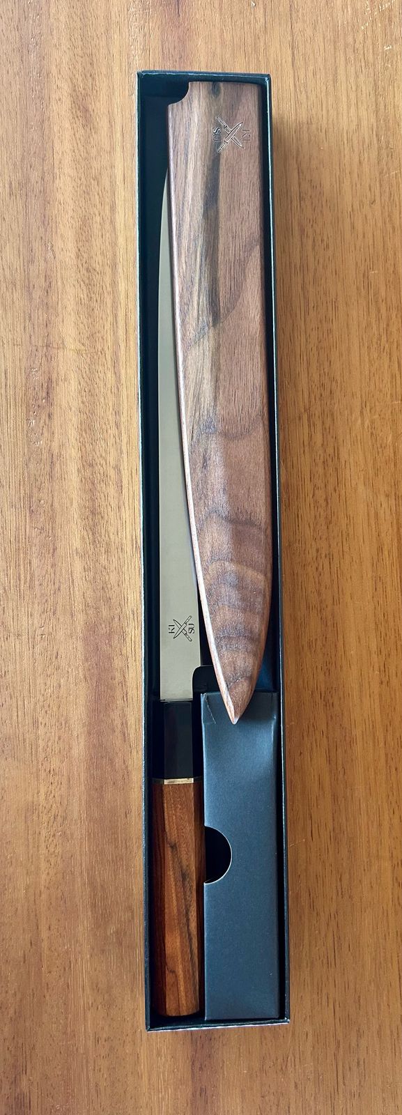 Single Bevel Stainless Steel Yaggiba Sushi Knife in packaging, featuring a sleek, angled blade and ergonomic handle.