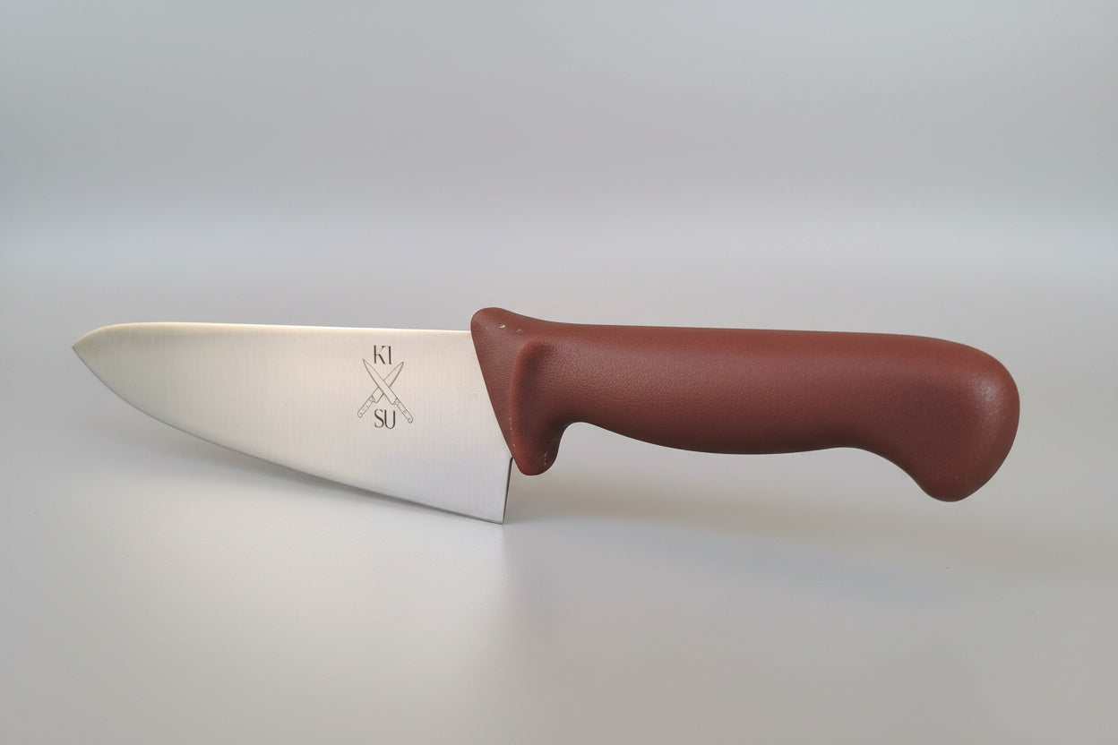 Knife with a brown handle on a metallic surface, blurred indoor background