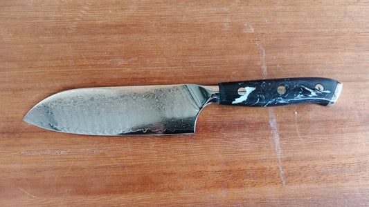 Santuko 7-inch knife with wooden handle on a cutting board