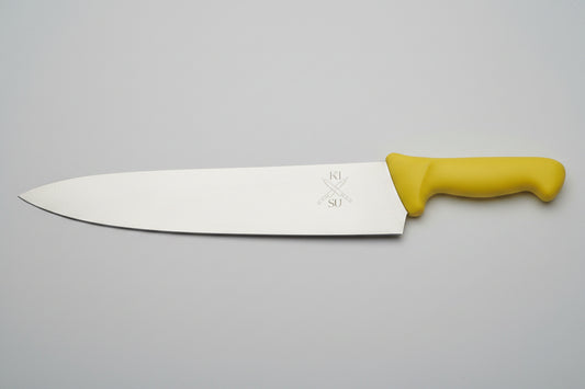 Large knife with a yellow handle on a wooden surface