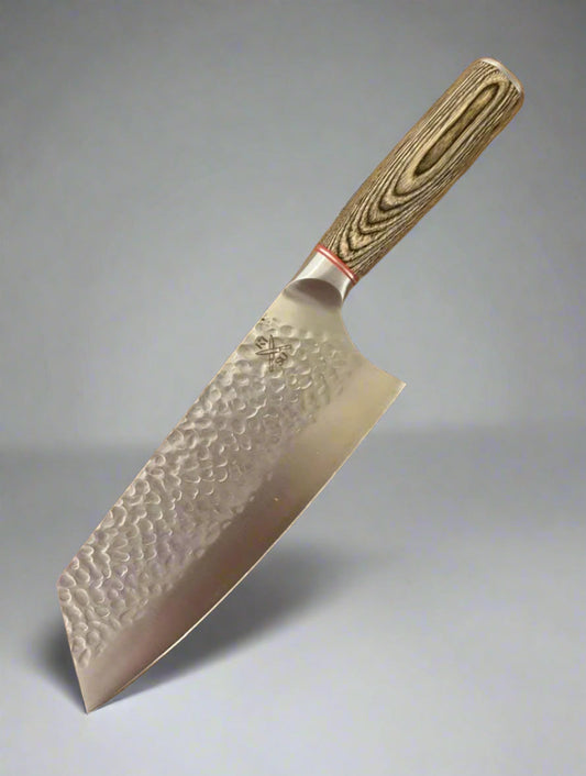 Rugged stainless steel Bunka chef knife with PAKKA wood handle, featuring a hammer-forged blade designed for toughness and corrosion resistance.
