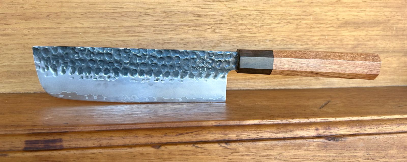 Premium Tokai Range Nakiri knife with Damascus steel blade and Mkuruti wood handle.