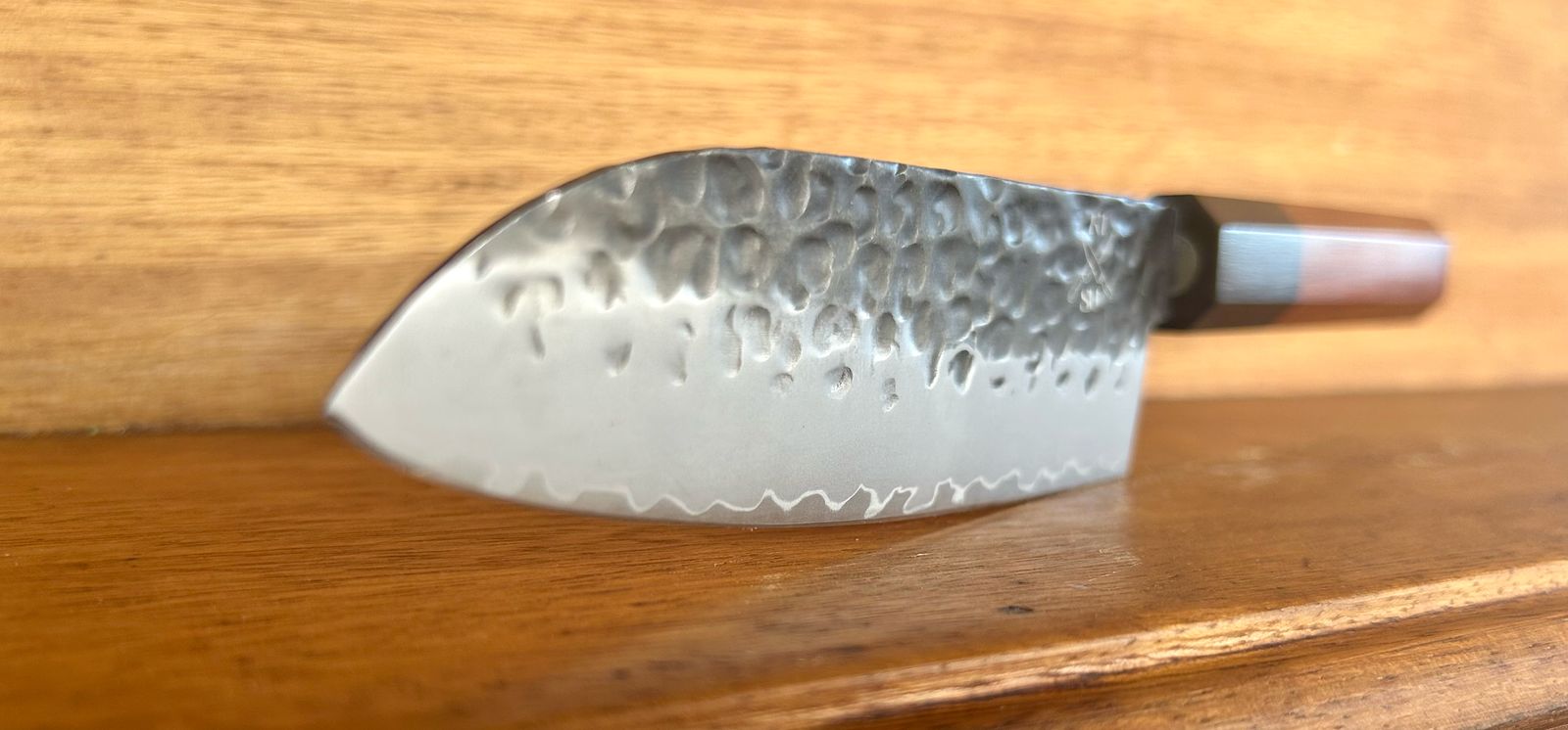 Japanese Tokai Range Santoku knife with AUS10 Damascus steel blade and Mkuruti wood handle.
